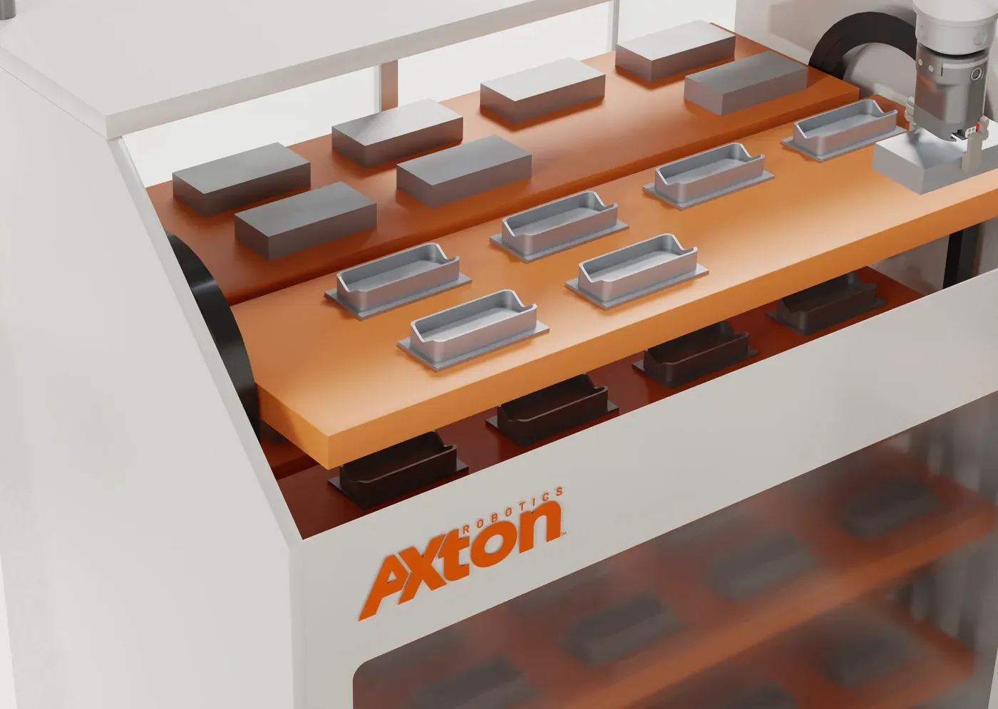 Raw blocks and finished machined parts on the top tray of the Axton Robotics carousel, with the cobot gripper