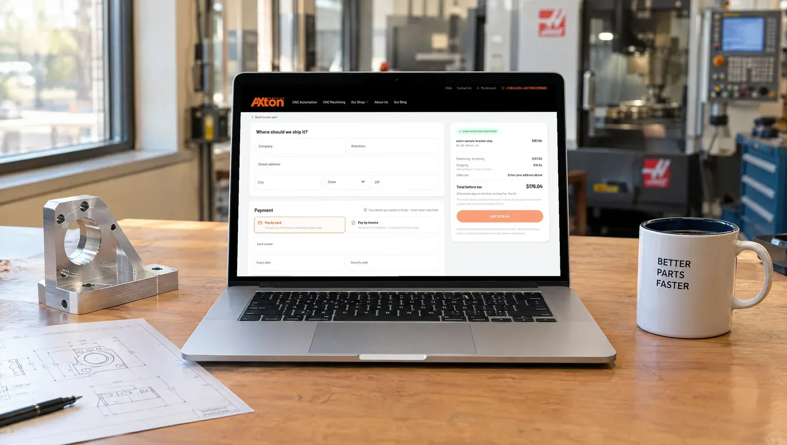 Laptop on a desk showing the Axton checkout page with shipping, payment and order summary
