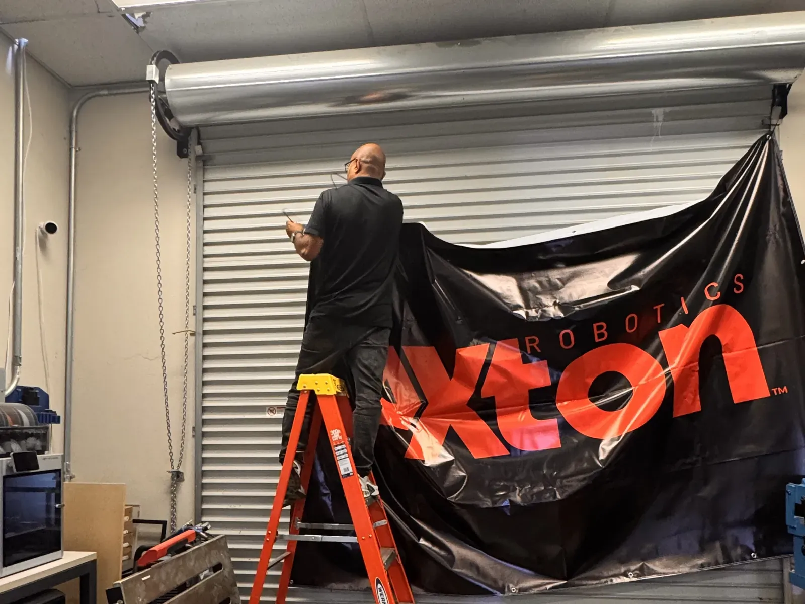 Hanging the Axton Robotics banner in the shop